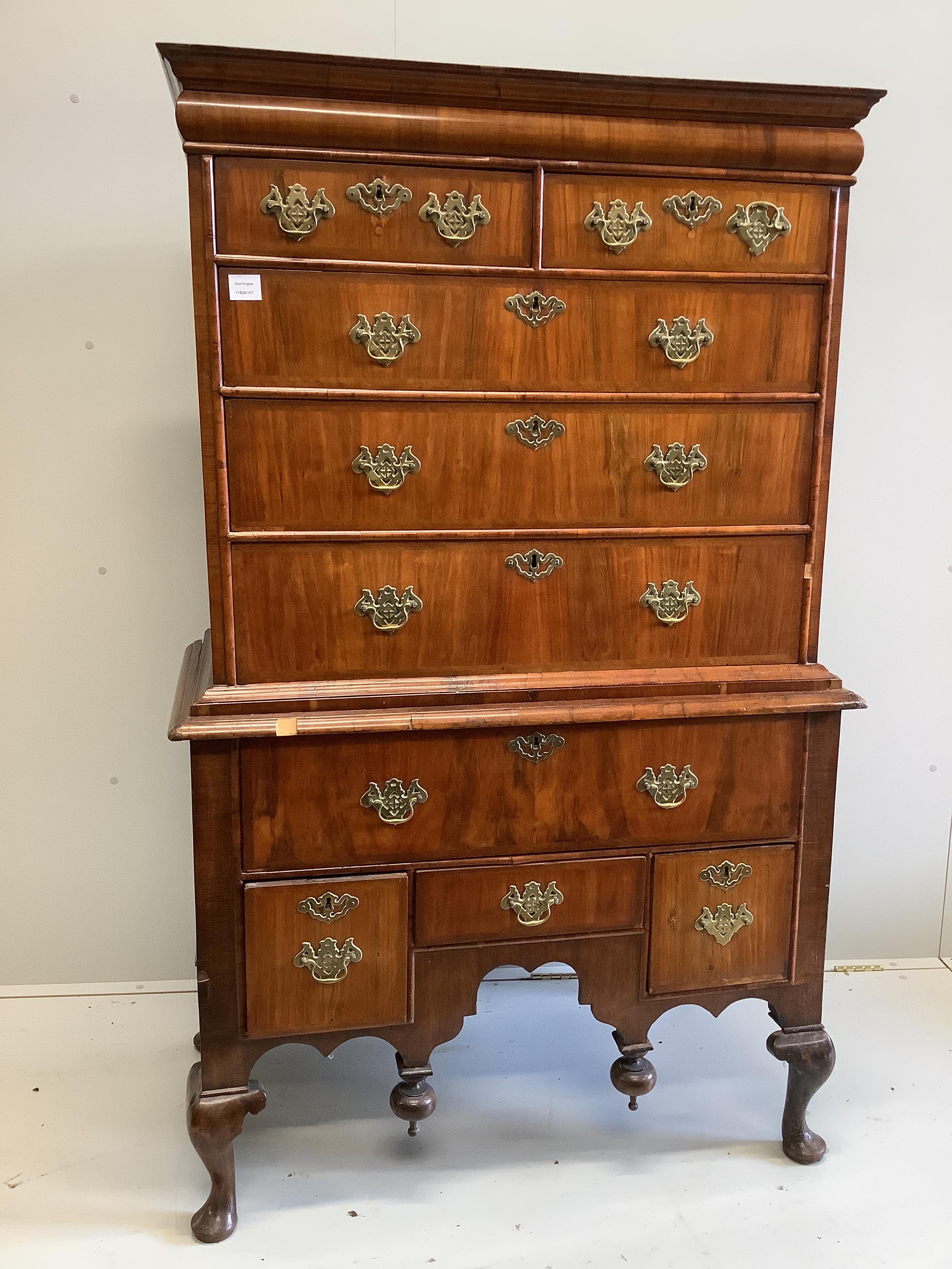 A George I and later feather banded walnut chest on stand, width 103cm, depth 58cm, height 167cm